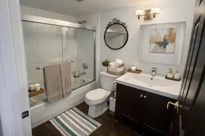 a bathroom with a toilet and a sink and a shower at Elegant 2-Bedroom Condo in Vibrant Yaletown District in Vancouver