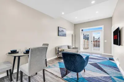 a living room with a table and chairs at 2 Bedroom Smart Secondary Suite with Gazebo view in Calgary