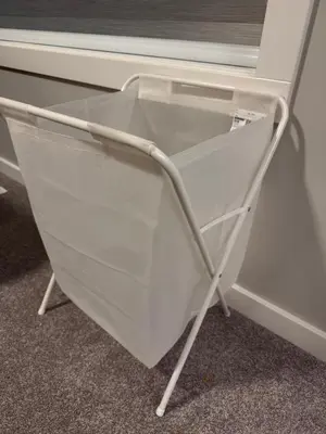 a white shopping cart in front of a window at NorthEdge Master Suite, Leduc in Leduc