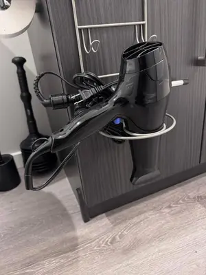 a hair dryer in a holder on a door at NorthEdge Master Suite, Leduc in Leduc