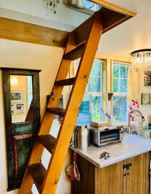 a wooden ladder in a kitchen with a counter at Magnolia Petal Accommodation in Salt Spring Island