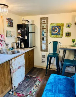 a kitchen with a sink and a counter with a microwave at Magnolia Petal Accommodation in Salt Spring Island
