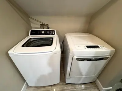 a washer and dryer in a small room at A Cozy Nest, Private Tiny Home in Vancouver