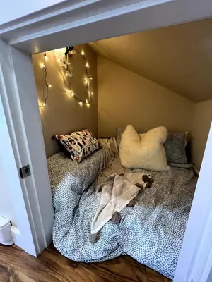 a room with a bed in a corner with lights at A Cozy Nest, Private Tiny Home in Vancouver