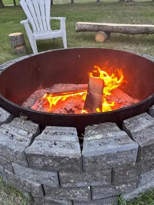 a large grill with a fire in it at Cozy Country Cabin in Lacombe
