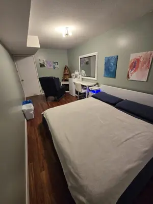 a bedroom with a large bed and a desk at Private Entrance OFFICE SPACE King Suite in Mission City