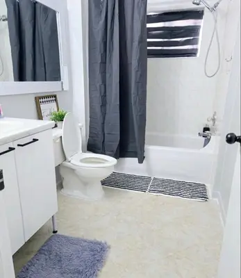 a bathroom with a toilet and a tub and a sink at Bohemian Theme Private Room near Metrotown Mall with private parking in Burnaby