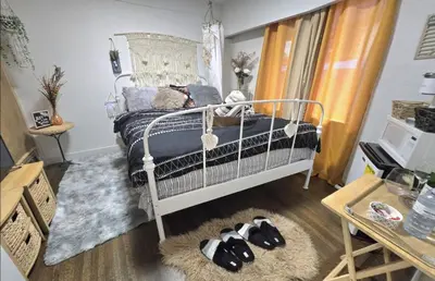 a bedroom with a bed with two stuffed animals on the floor at Bohemian Theme Private Room near Metrotown Mall with private parking in Burnaby