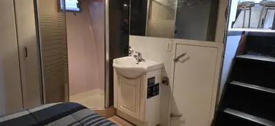 a small bathroom with a sink and a shower at Shangri-la Joy in Vancouver