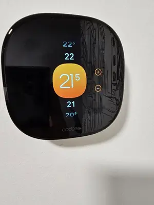 a digital clock on a wall with the number twentyfive at 2BR 14minsYYC Airport Private Entrance Soft Water System in Calgary