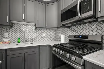 a kitchen with a stainless steel stove and microwave at Bright & Spacious Family Retreat in Calgary