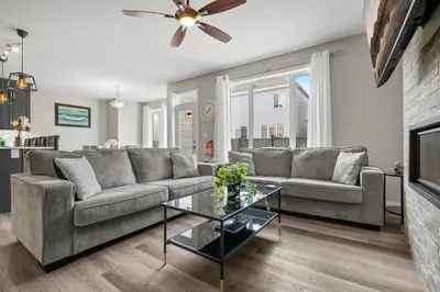 a living room with a couch and a table at Bright & Spacious Family Retreat in Calgary