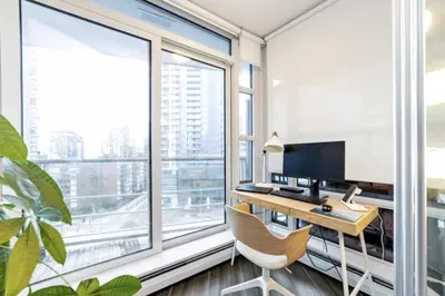an office with a desk with a computer and a large window at 25 Days Minimum - Luxury and Modern Downtown Apartment - Do not send request for less than 21 days in Vancouver