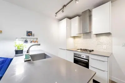 a kitchen with white cabinets and a sink at 25 Days Minimum - Luxury and Modern Downtown Apartment - Do not send request for less than 21 days in Vancouver