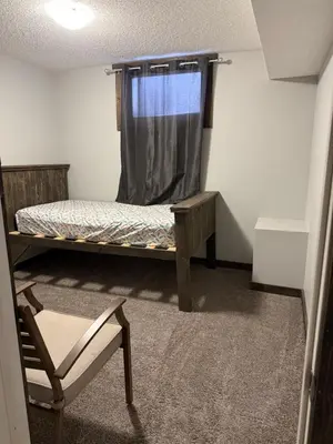 a small room with a bed and a window at Cowboy Cabin- Lakefront Rental Northern Saskatchewan
