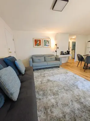 a living room with a couch and a table at 2 bedroom suite close to Main and Skytrain in Vancouver