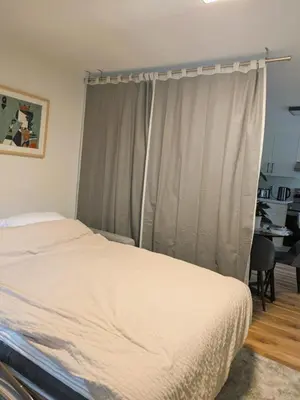 a bedroom with a bed and a window at 2 bedroom suite close to Main and Skytrain in Vancouver