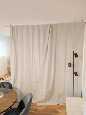 a white curtain in a room with a table and chairs at 2 bedroom suite close to Main and Skytrain in Vancouver
