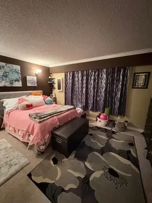 a bedroom with a bed and a camouflage rug at Oasis in Surrey