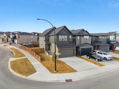 a house with a car parked in a driveway at Herron Rise Luxury 1 Bedroom Basement Suite in Calgary