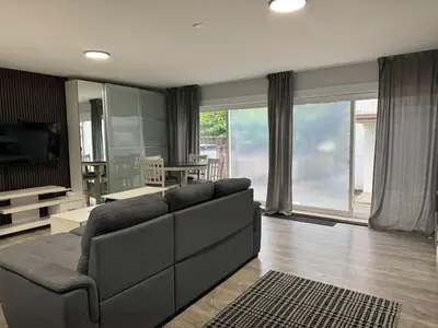 a living room with a couch and a dining room at Super bright and beautiful home with all you need in Delta