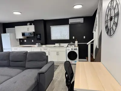 a living room with a couch and a kitchen at Super bright and beautiful home with all you need in Delta