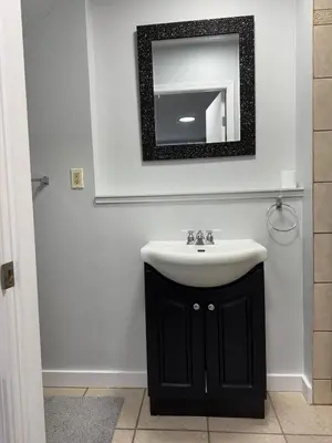 a bathroom with a sink and a mirror on the wall at Super bright and beautiful home with all you need in Delta