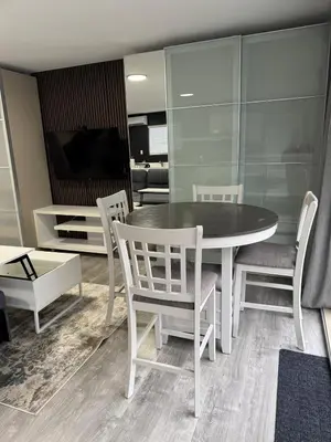 a dining room with a table and chairs and a television at Super bright and beautiful home with all you need in Delta