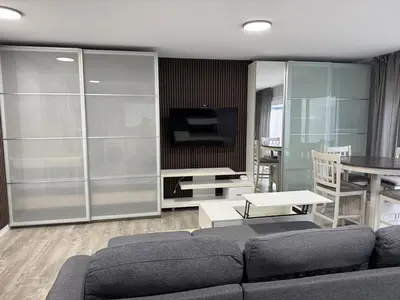 a living room with a couch and a television at Super bright and beautiful home with all you need in Delta