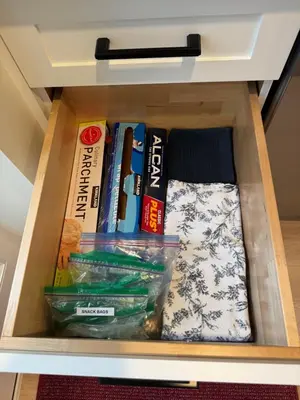 a drawer in a cabinet filled with books at Rosie Cozy Retreat in Victoria