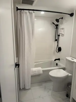 a bathroom with a tub and a toilet and a shower at Rosie Cozy Retreat in Victoria