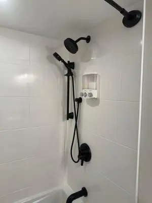 a bathroom with a shower with a shower head at Rosie Cozy Retreat in Victoria