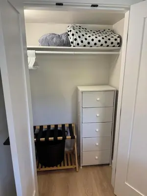 a bedroom with a closet with a bed and a dresser at Rosie Cozy Retreat in Victoria