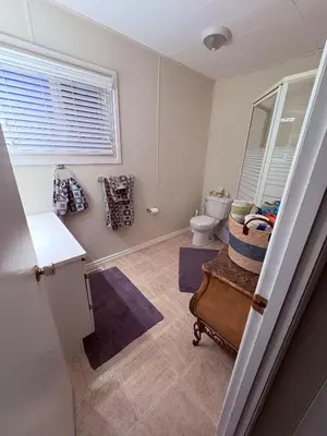 a bathroom with a toilet and a sink at Spacious 4-Season Cabin with Lakefront Views in Silver Sands in Seba Beach