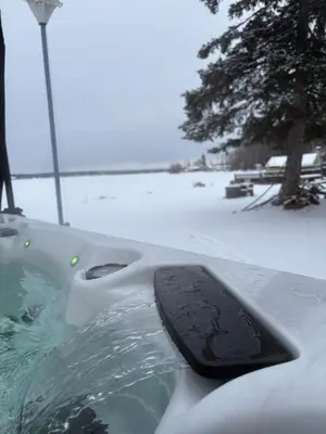 a bath tub covered in snow with a snow covered ground at Spacious 4-Season Cabin with Lakefront Views in Silver Sands in Seba Beach