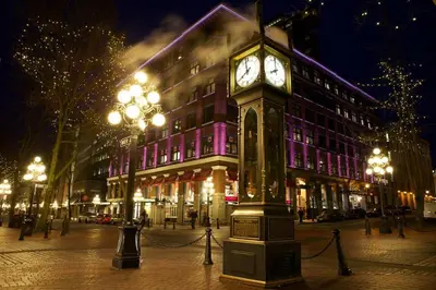 a clock tower on a city street at night at Luxury High Rise at Gastown Near BC Place in Vancouver