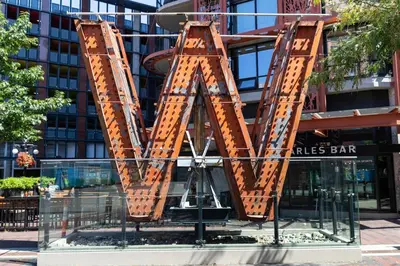 a sculpture of a letter m in front of a building at Luxury High Rise at Gastown Near BC Place in Vancouver