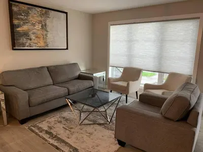 a living room with a couch and two chairs at New townhouse in Red Deer -Family retreat in Red Deer