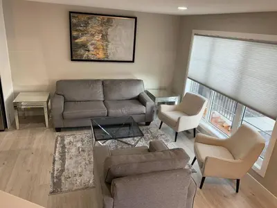 a living room with a couch and two chairs at New townhouse in Red Deer -Family retreat in Red Deer
