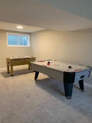 a ping pong table in a room with a table at New townhouse in Red Deer -Family retreat in Red Deer