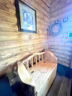 a wooden room with a bench and a picture on the wall at The Lynx cabin - Bear Creek Cabins in Winfield