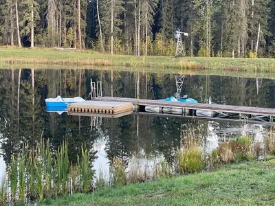 a dock on a lake with two boats on it at The Deerview cabin - a part of Bear Creek Cabins in Winfield