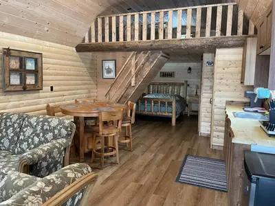 a kitchen and dining room with a table and chairs at The Cowboy cabin - Bear Creek Cabins in Winfield
