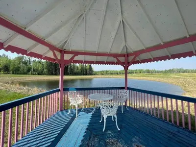 a patio with a table and chairs on a deck at The Moose cabin - Bear Creek Cabins in Winfield