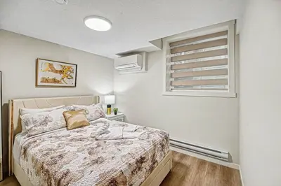 a bedroom with a bed and a window at Stylish 2BR Townhome - Near YYC Airport - Free Parking in Calgary