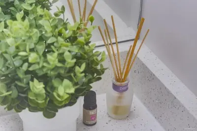 a bottle of essential oils next to two potted plants at The Cozy Garden Suite - South Surrey Stay in White Rock