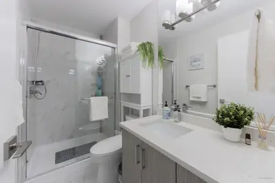a bathroom with a shower and a toilet and a sink at The Cozy Garden Suite - South Surrey Stay in White Rock