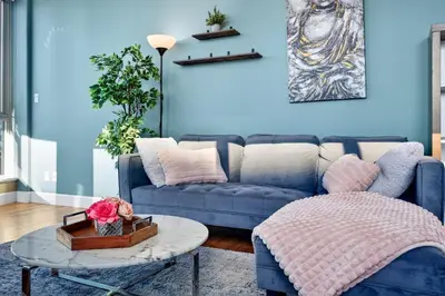 a blue living room with a couch and a table at Stunning 2BR Apartment with Best Mountain View Downtown in Vancouver