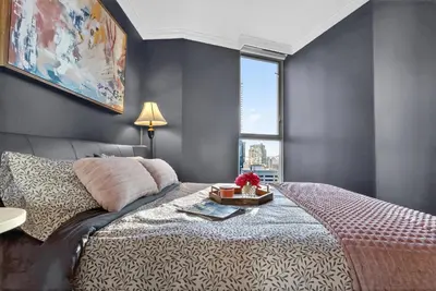 a bedroom with a large bed and a window at Stunning 2BR Apartment with Best Mountain View Downtown in Vancouver