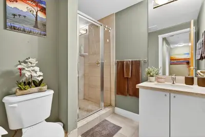 a bathroom with a shower and a toilet and a sink at Stunning 2BR Apartment with Best Mountain View Downtown in Vancouver